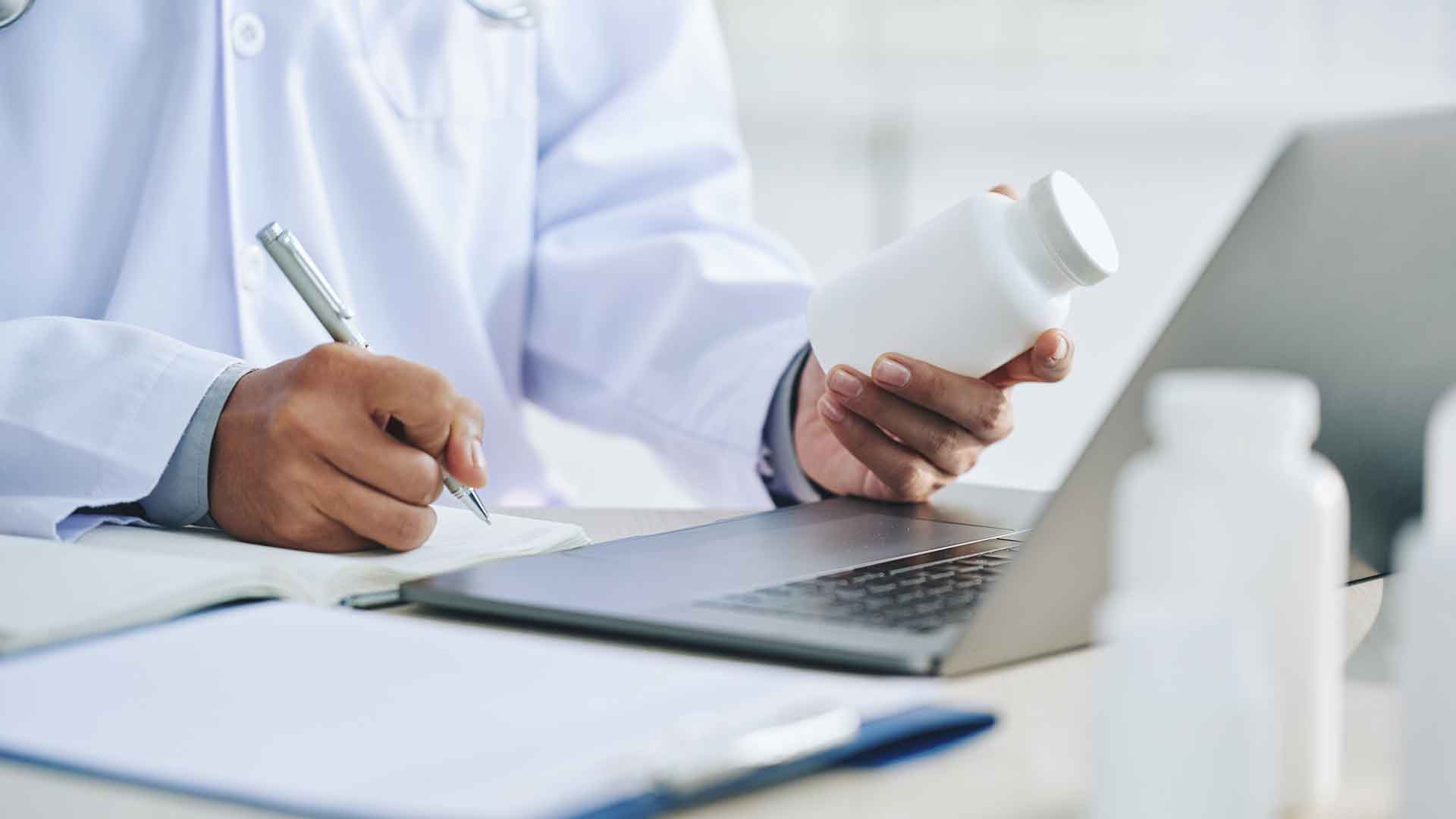 a doctor holding a bottle and pen