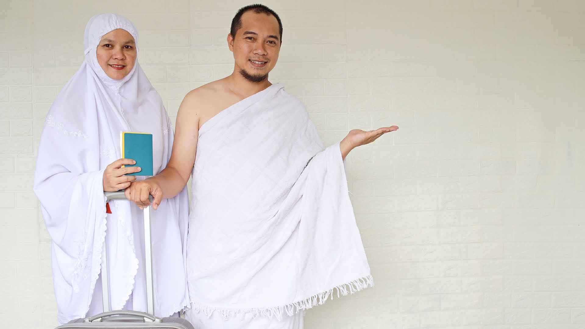 a man and woman wearing white robes