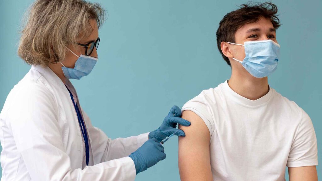 a doctor injecting a patient